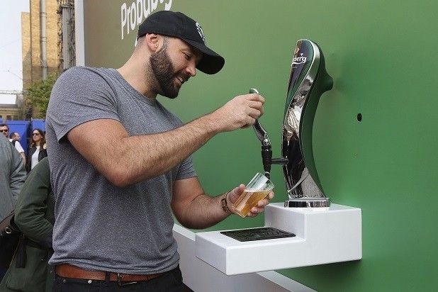 A man having beer from Carlsberg creative billboard ad of the "The Nest Poster in the World"