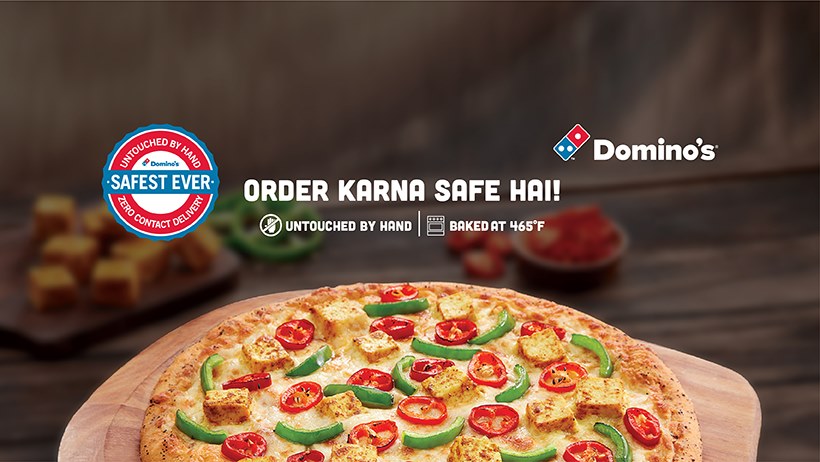 This image shows a pizza with Order Karna Safe Hai and Domino’s logo
