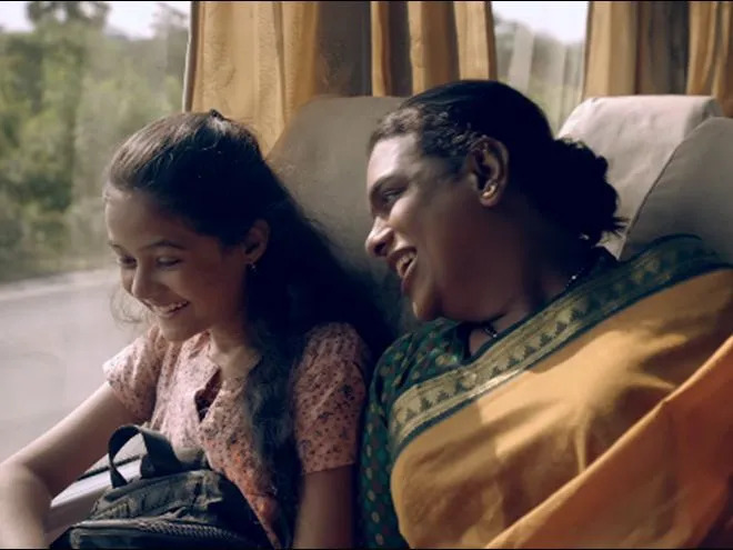 The image shows a transgender woman with a girl going on a bus