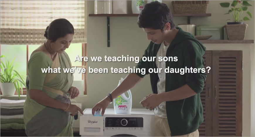 This image represents Ariel Matic's #ShareTheLoad marketing campaign with a son assisting his mother with laundry