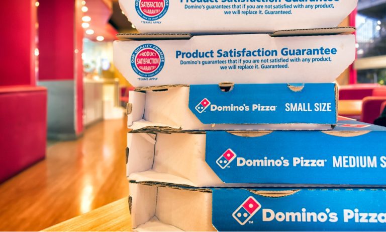 This image shows different sizes of pizza boxes with Domino’s branding for different sizes of pizzas 