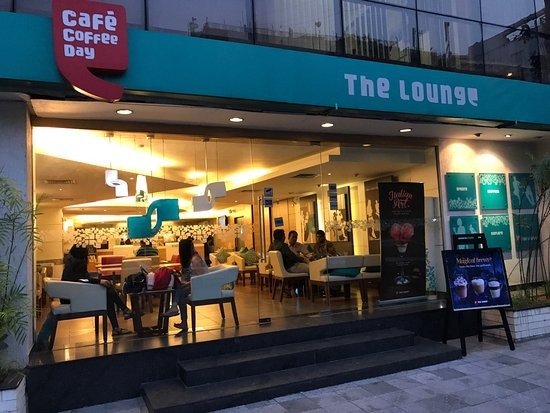 This image shows a people sitting in the Lounge outlet of Cafe Coffee Day