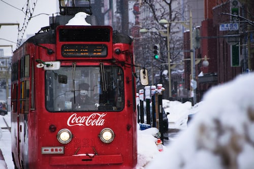 A mobile van showcasing coca cola ads.