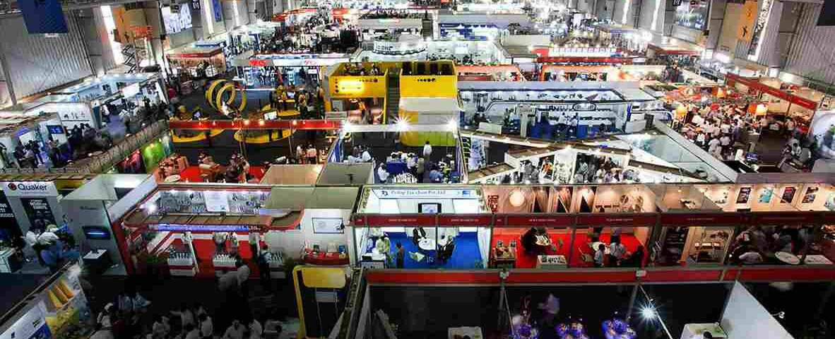 This image shows a trade fair in Delhi with several brands and people in one place