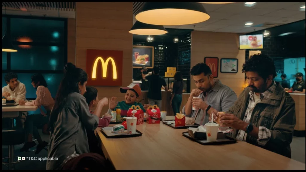 Picture showing McDonald's advertising a few people on the table enjoying the meal.