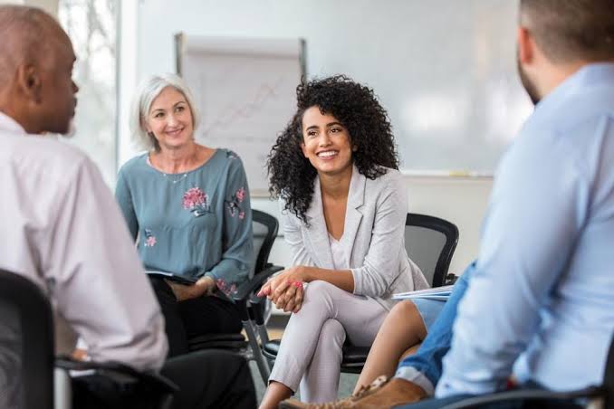 People sitting together with smiles on their face