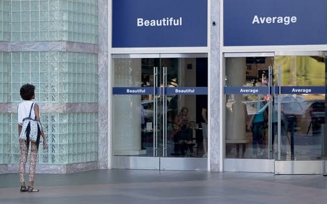 A woman is faced with two signs beautiful and average and has to choose one