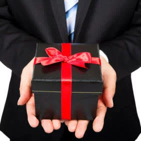 It shows a man opening a gift
