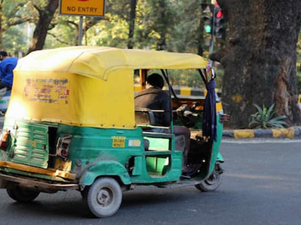 An auto featuring a poster advertisement on its rear side.