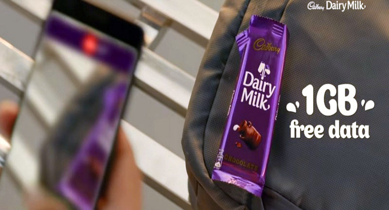 A person clicking a photo of the Cadbury wrapper.