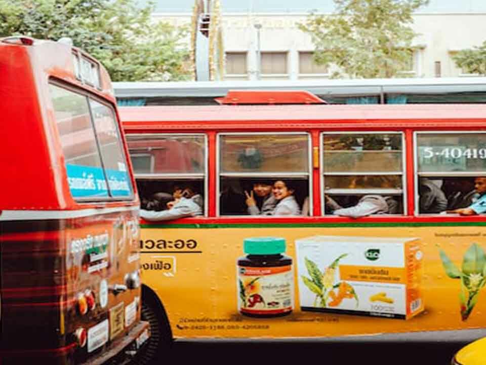 A public bus featuring the advertisement of a popular pharma brand.