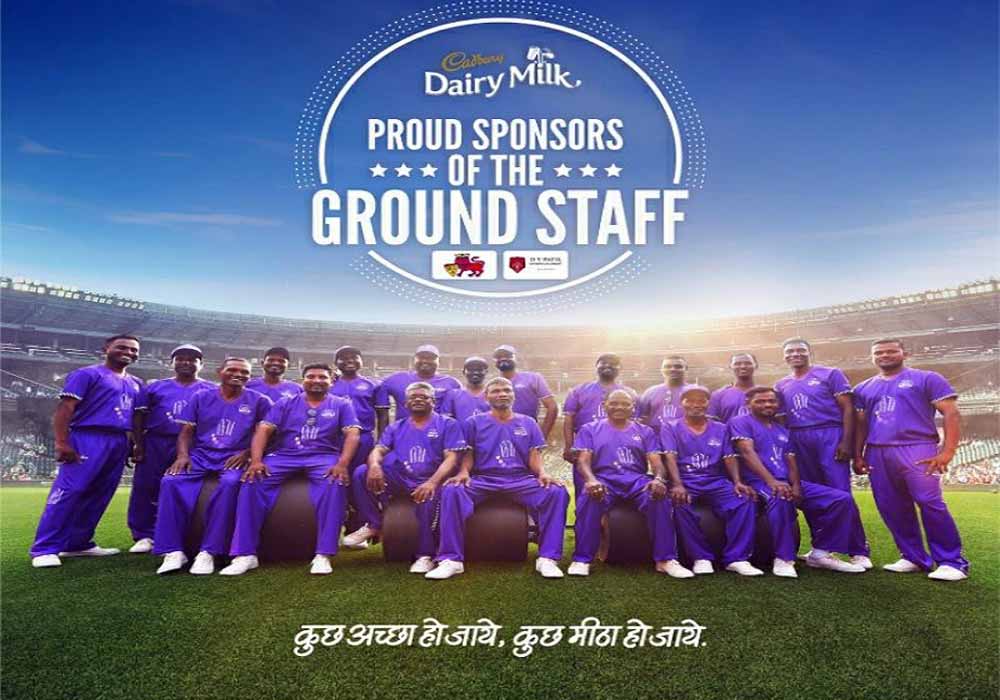 A group photo featuring the IPL 2022 ground staff in Indian jerseys.